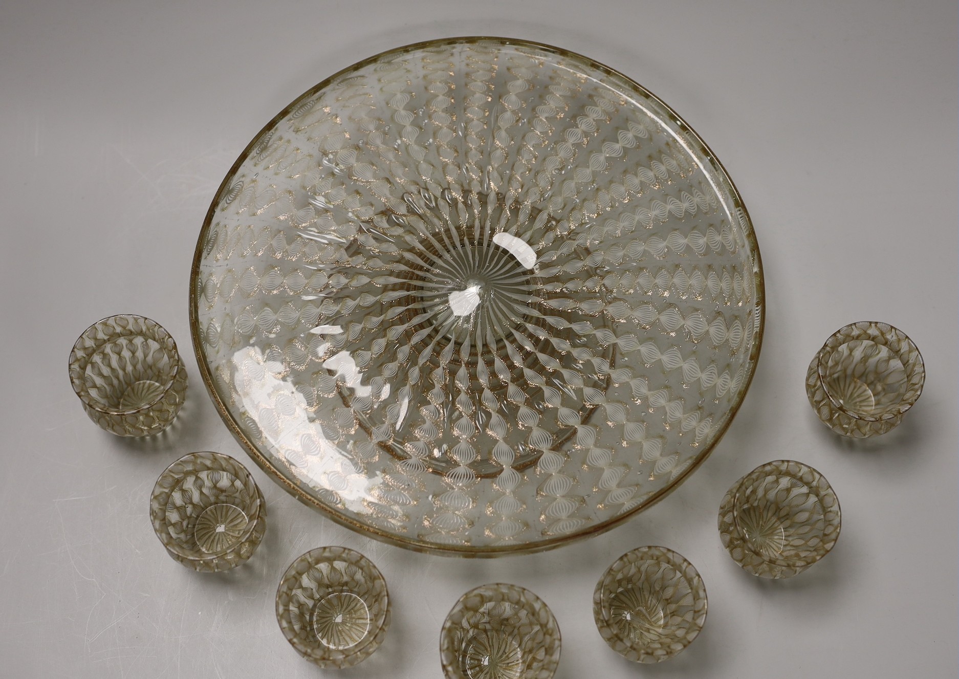 An Italian Salviati latticino and aventurine glass apperitif set, pedestal tray, seven glasses and a carafe